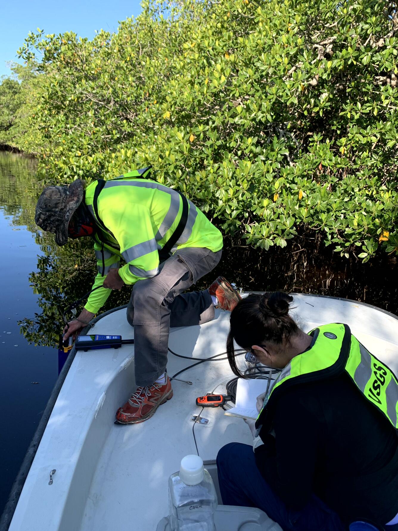 Two scientists sampling water in the Shark River Slough in Everglades National Park, Florida
