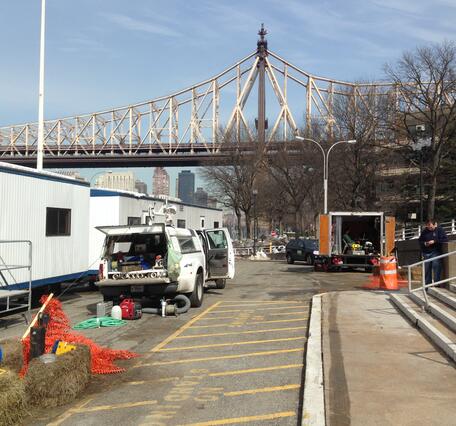 Two USGS trucks filled with geophysical logging equip. on NYC street